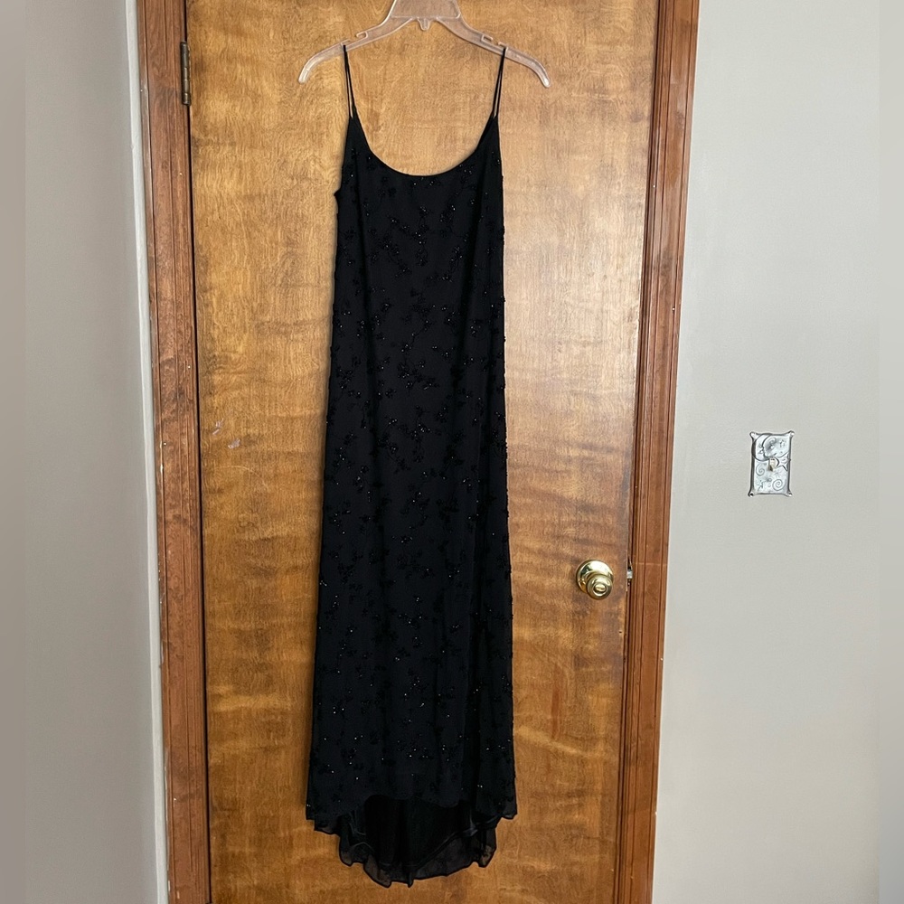 Like new worn once black fully beaded and lined dress. A tiny train in back.